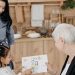A family sharing a joyful moment as a child presents a drawing, emphasizing love and connection.